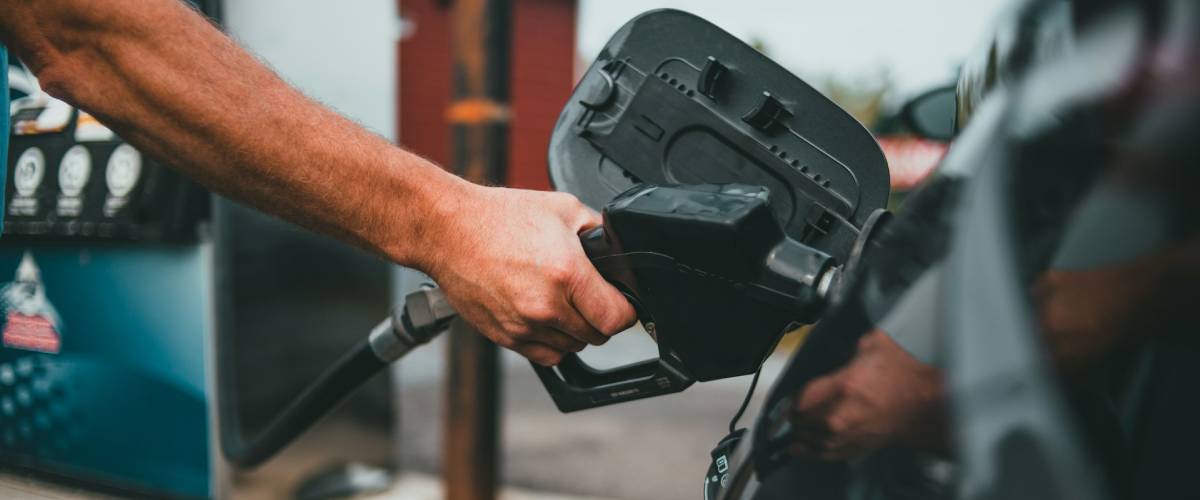 A person filling up their car with petrol