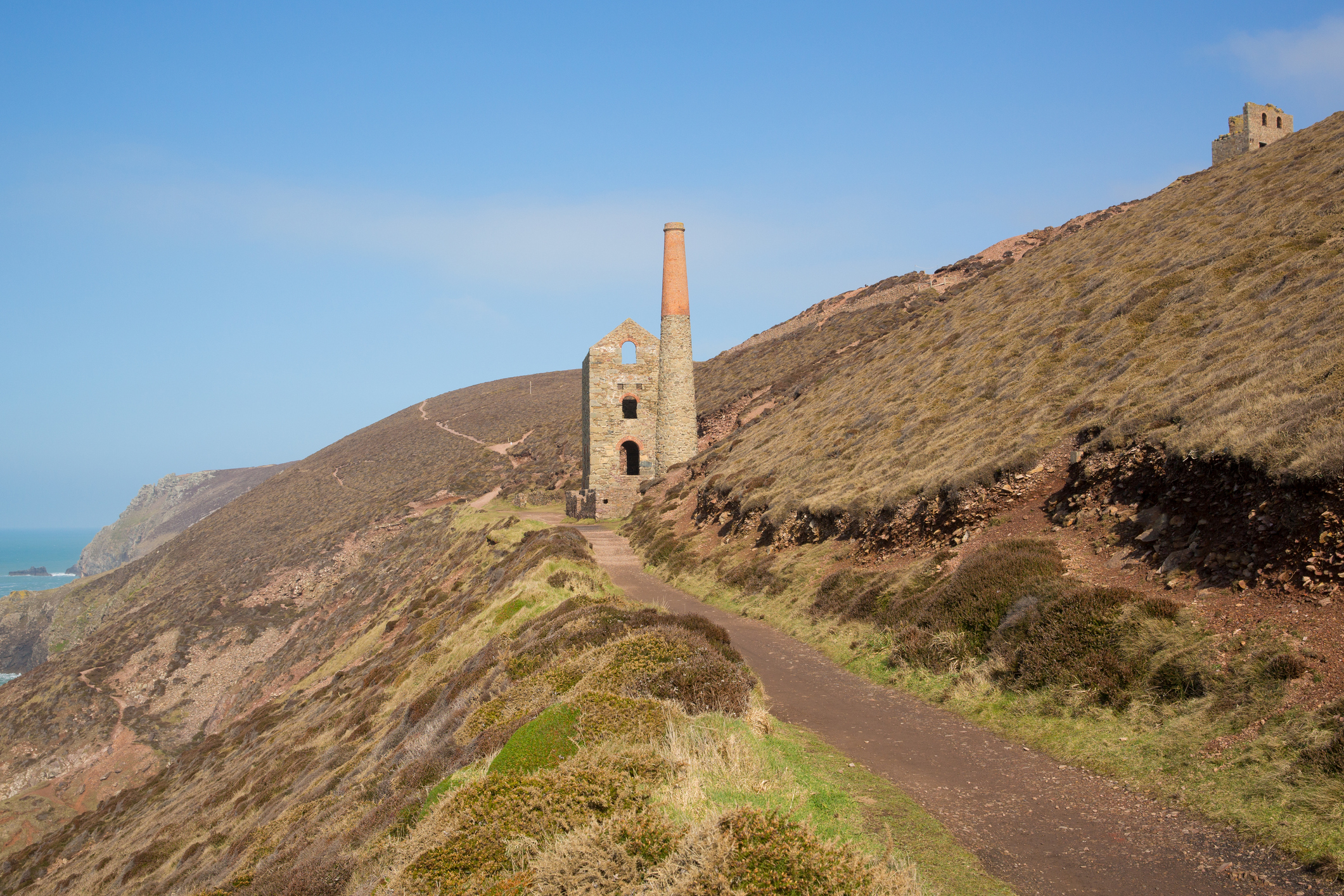 Historic mining engine house on a Cornish clifftop along St Michael’s Way footpath with rugged moorland and sea views in the background.